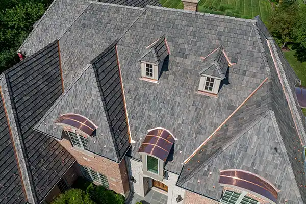 Large home with a gray tile roof